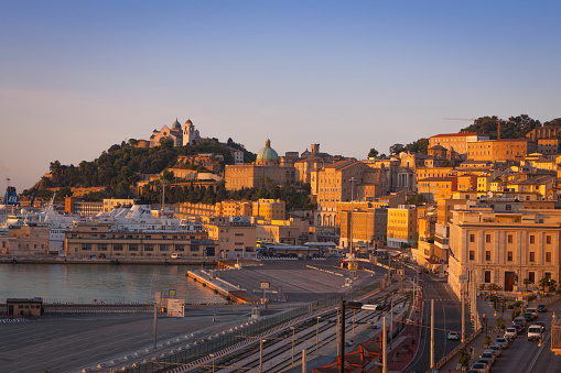 Ancona, Italy - August 28, 2015: View towards the ferry terminal and the historical city center of Ancona in central Italy. The port has regular ferry links to Croatia, Albania and Greece. The hillside is dominated by the 13th century landmark church, the cathedral of San Ciriaco. 
