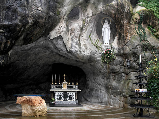 Statue of the Virgin Mary in the grotto of Lourdes Statue of the Virgin Mary in the grotto of Lourdes attracts many pilgrims from all over the world 1 grotto cave photos stock pictures, royalty-free photos & images