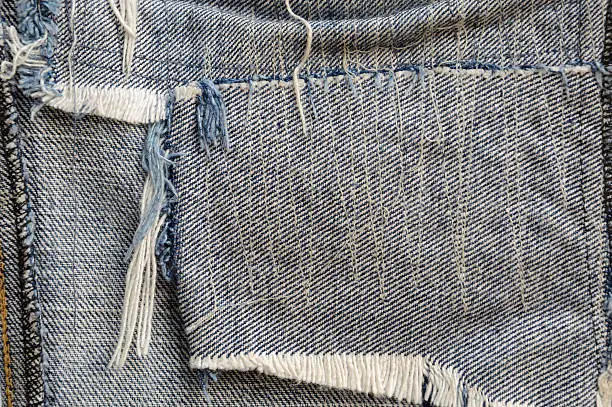 close up ragged fabric of old bluejeans