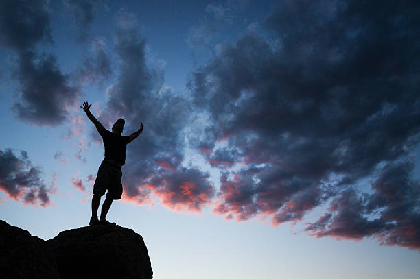istock sunset silhouette spiritual man 485898697