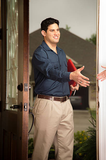 istock Service Industry: Repairman or inspector greets customer at home. 485898849