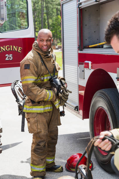 istock Firefighters next to fire rescue truck putting on gear 485901642