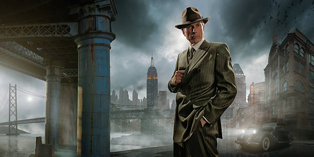 Retro 1940's Film Noir Detective or Gangster Retro image of a 1940’s film noir mature gangster / private detective wearing a suit and fedora hat, pulling out a pistol / gun from his jacket. He stands on a dock by a vintage car with a generic city in the background, under a dark and stormy evening sky. Sign is fictional.  film noir style stock pictures, royalty-free photos & images