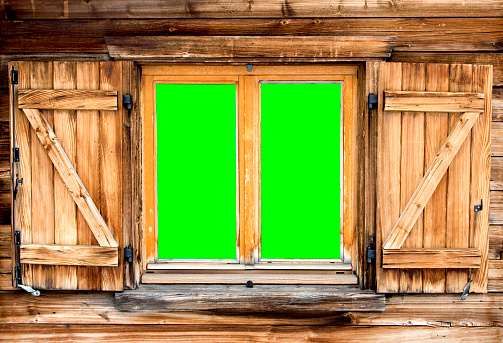 Weathered  facade of a mountain hut with green screen background