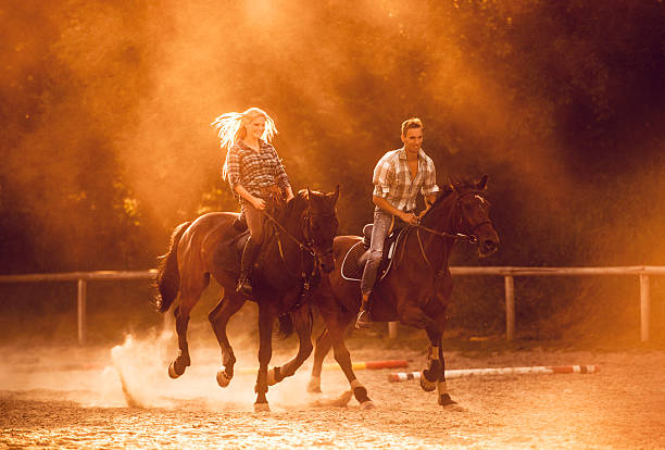 istock Happy couple practicing with their horses at sunset. 485904630