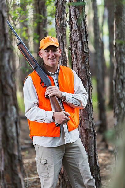 istock Man in woods hunting with shotgun 485904992