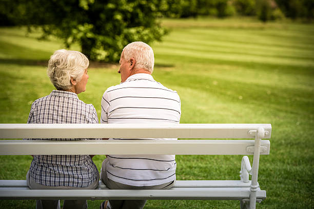 istock Senior couple sitting in park 485907768
