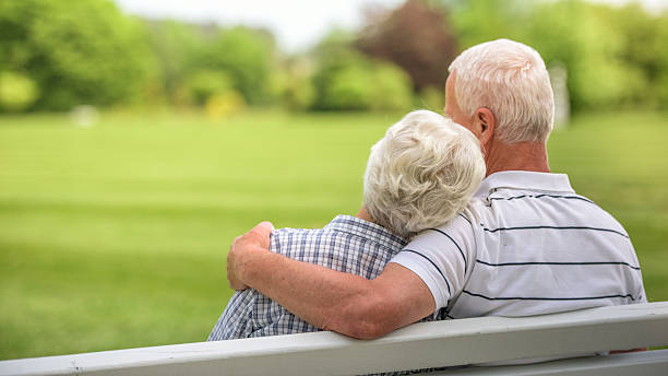 istock Senior couple sitting in park 485907844
