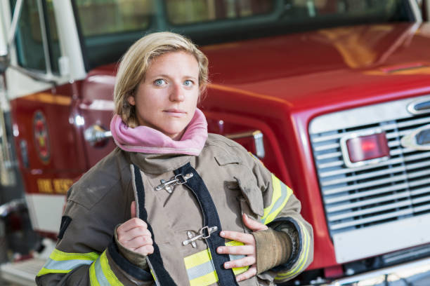 istock Female firefighter in front of fire truck 485916506