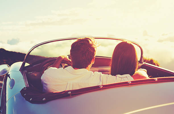 istock Couple Watching the Sunset in Classic Vintage Car 485916558