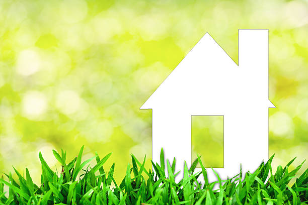 istock White paper house and spring grass with green bokeh 485919701