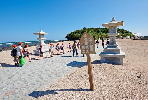 Aoshima, Japan - September 26, 2014: schoolchildren and tourists entering at Aoshima Island. The island is a popular tourist destination in Miyazaki Prefecture.