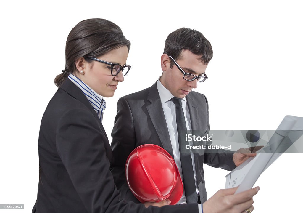 Couple of architects revising house project Couple of architects revising a house project plans, isolated on white background Adult Stock Photo