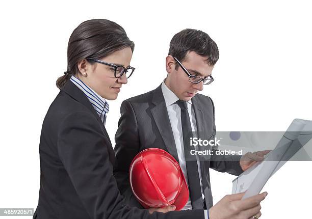 Couple Of Architects Revising House Project Stock Photo - Download Image Now - Adult, Architect, Architecture