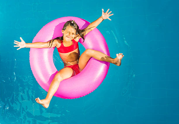istock Little girl in a swimming pool 485920881