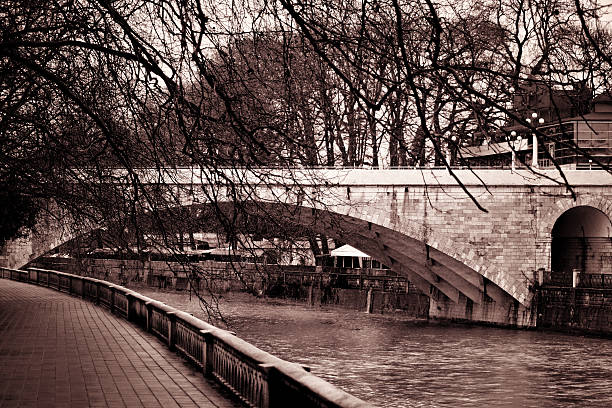 River Great Ouse in flood at Godmanchester with an ornamental pedestrian Bridge in the background. This area is protected from flooding by a large weir.