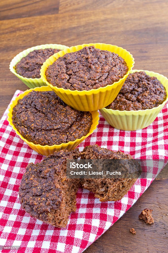 Home made chocolate muffins on a napkin Five freshly baked chocolate muffins. Baked Stock Photo