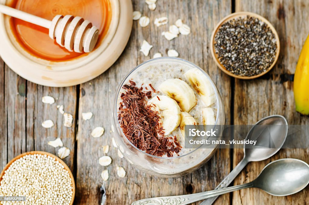 overnight banana oats quinoa Chia seed pudding overnight banana oats quinoa Chia seed pudding decorated with banana and chocolate. the toning. selective focus 2015 Stock Photo