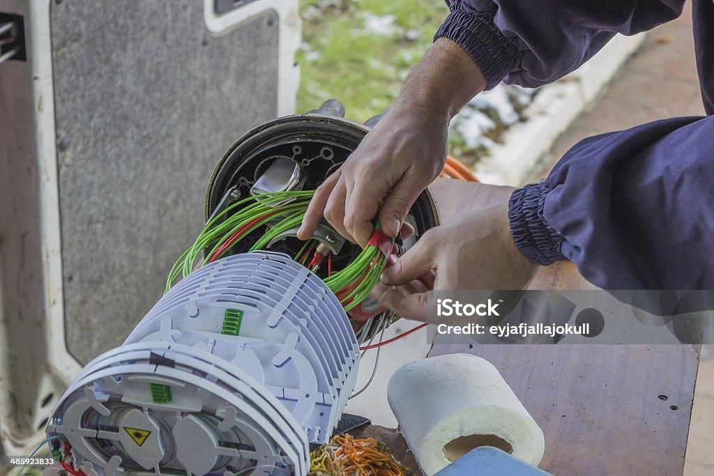 Fibre optic technician rolls of fibre-optic cables Fibre optic technician rolls of fibre-optic cables inside a splice organiser tray. Fiber Optic Stock Photo