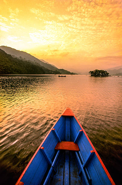 Nepal, Kaski District, Pokhara, boats on Lake Phewa at sunset.