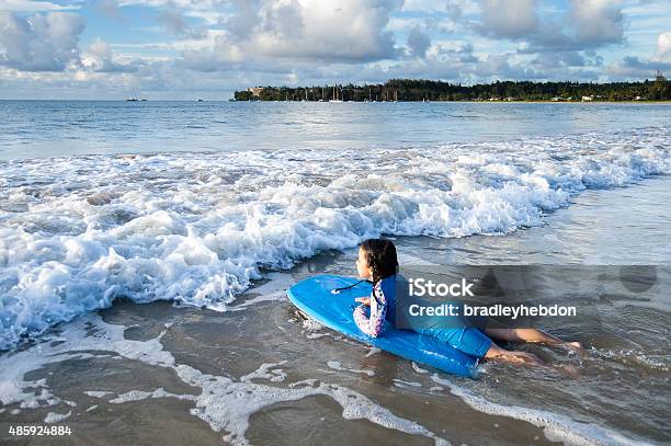 Little Surfer Girl Paddling Out On Her Bodyboard Stock Photo - Download Image Now - Paddling, 2015, 4-5 Years