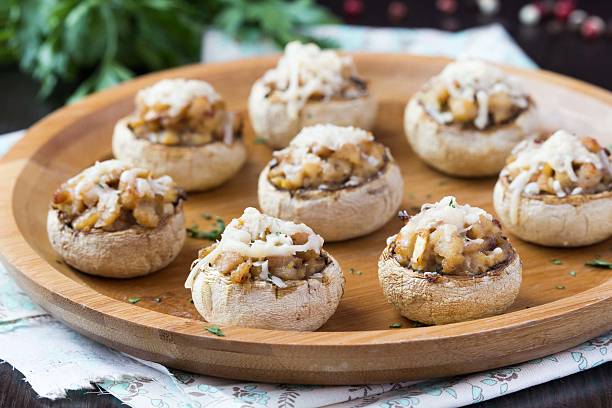 Mushroom champignons stuffed with filling of chicken, cheese stock photo