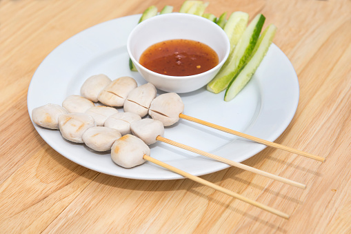 pork meat ball grilled and sauce on wood backgroundpork meat ball grilled and sauce on wood background