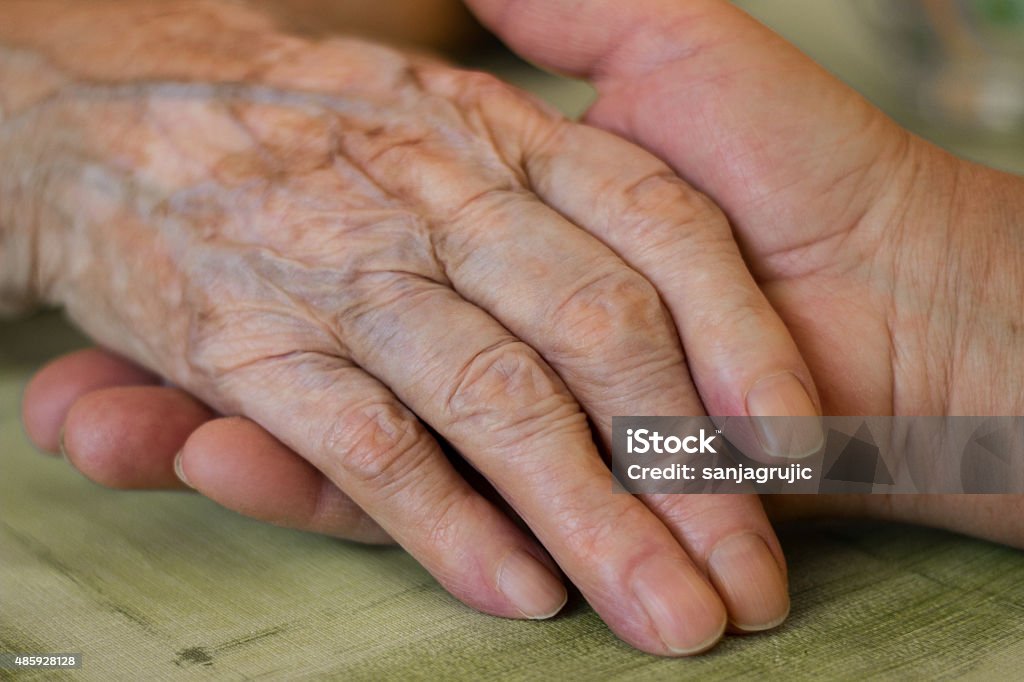Providing a helping hand Woman gives grandma her hand Senior Adult Stock Photo