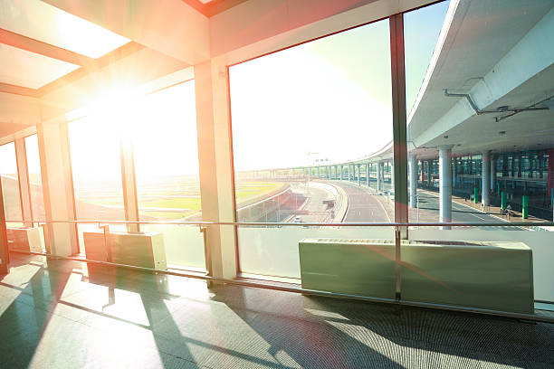 istock Sunshine on modern glass office building interior corridor 485930078