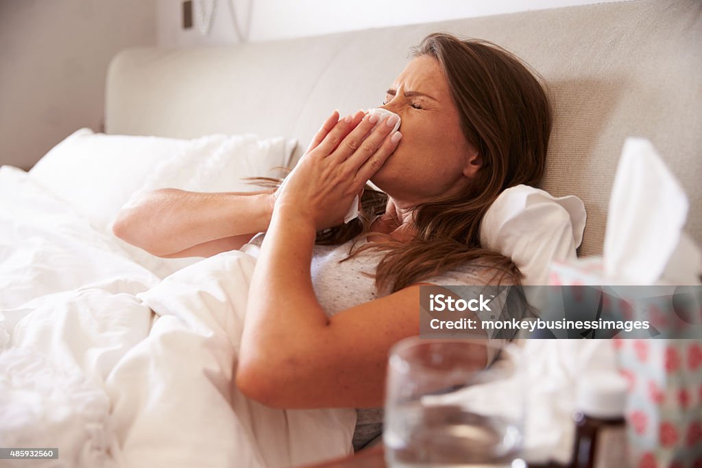 Woman Suffering From Cold Lying In Bed With Tissue 2015 Stock Photo