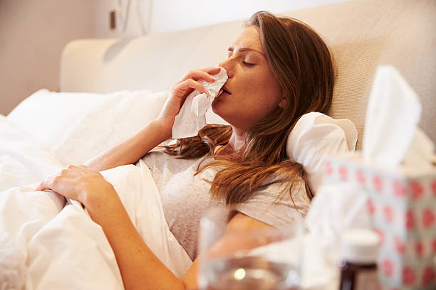 istock Woman Suffering From Cold Lying In Bed With Tissue 485932628