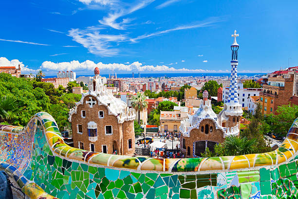 Parc Guell, Barcelona, Spain Parc Guell, Barcelona, Spain. Main entrance to Gaudi's Parc Guell and skyline of Barcelona. barcelona spain stock pictures, royalty-free photos & images