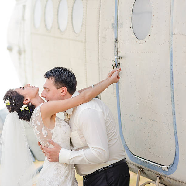 istock Bride and groom next to old aircraft. 485934688