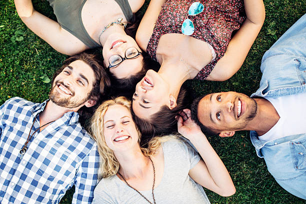istock Friends Having Fun Laying in Grass 485934904