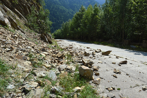 Rockfall in Carpathians where the road is covered with stones