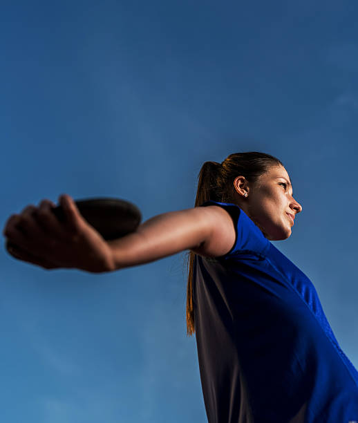 istock Athletic woman with discus against the blue sky. 485939226