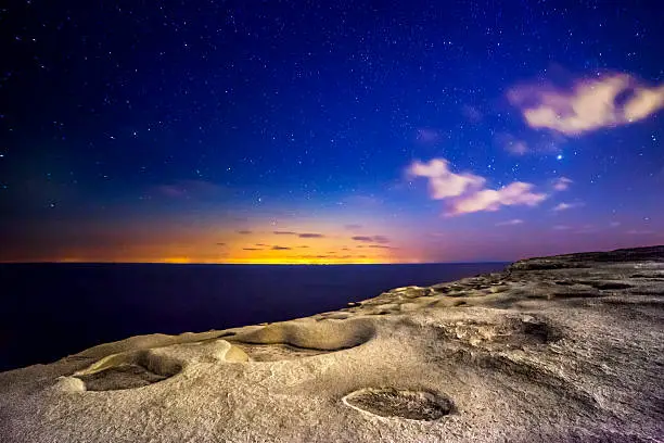 An almost alien and surreal landscape...actually shot on the island of Gozo.  The distant glare and lights are from the island of Sicily.