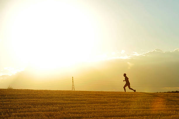 istock profile silhouette man running in countryside training in summer sunset 485942382