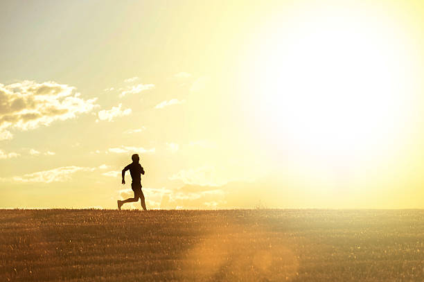 istock profile silhouette man running in countryside training in summer sunset 485942420