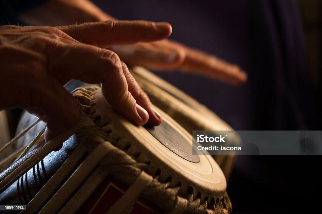 Hands Play Bongos Hands play bongos.  Dramatic lighting.   Percussion Instrument Stock Photo