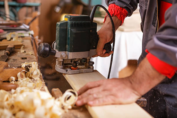 istock Carpenter at work with electric planer joinery 485944893
