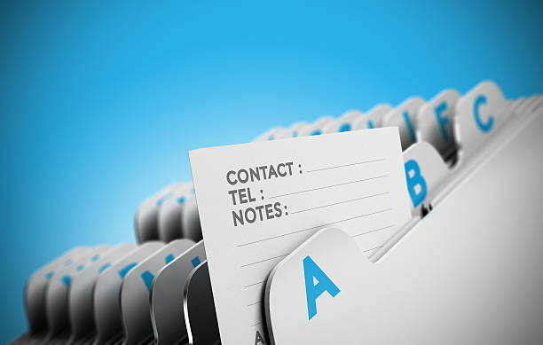 Customer File Concept Folder tab organized alphabetically with focus on a contact note, blue background. Conceptual business image for illustration of customer file, client data management or address list. alphabetical order photos stock pictures, royalty-free photos & images