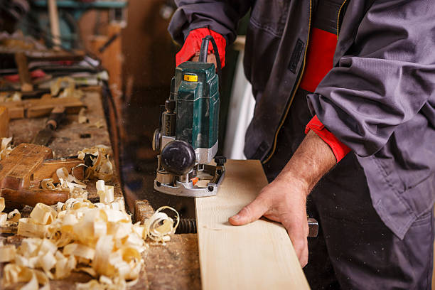 istock Carpenter at work with electric planer joinery 485947135
