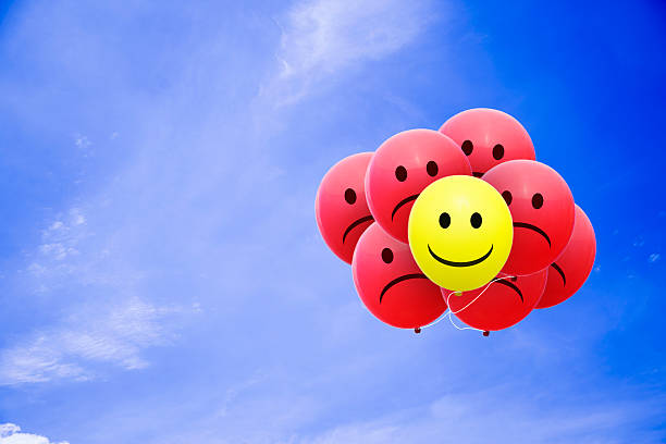 istock Bright balloons flying in the blue sky with a smiley 485948138