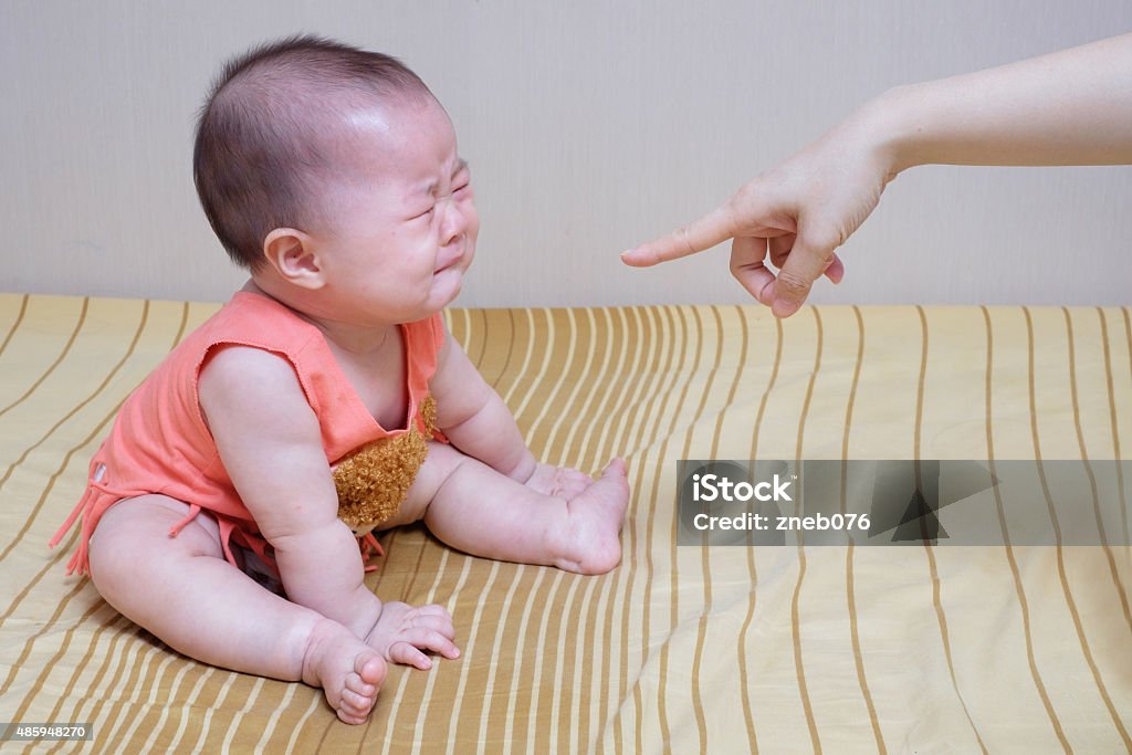 Asian baby crying while mother scolding Scolding Stock Photo
