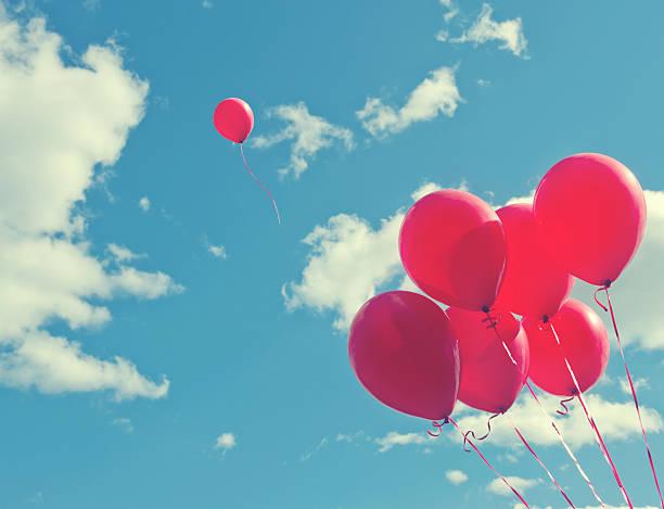 istock Bunch of red ballons on a blue sky 485948899