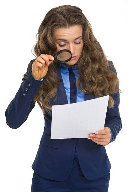 istock business woman exploring document with magnifying lens 485950017