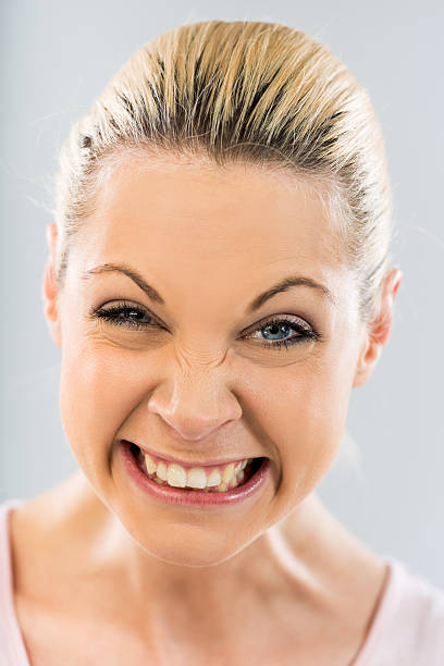 istock Young woman making a face and looking at camera. 485952322