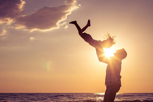 Father and son playing on the beach