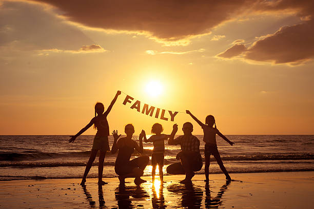 istock Happy family standing on the beach 485952858